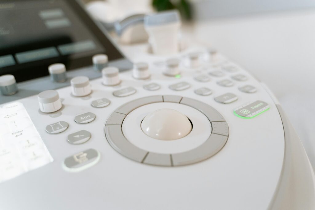 Detailed close-up of ultrasound machine controls in a medical facility.