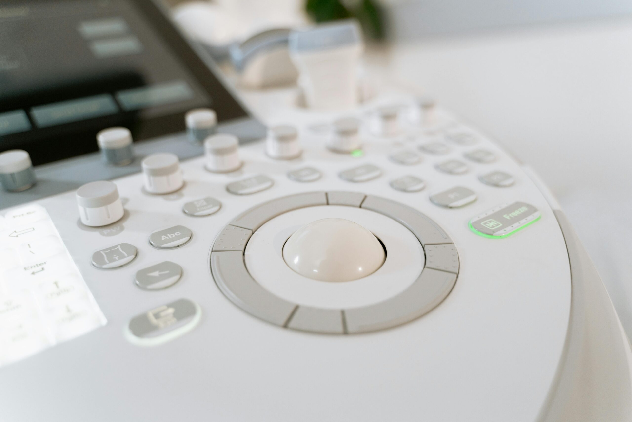 Detailed close-up of ultrasound machine controls in a medical facility.